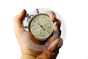 Vintage mechanical wind up stop watch held in left hand with fingers on reset positions, white background