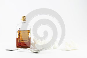 Vintage medicine bottle with silver spoon and handkerchiefs on white background