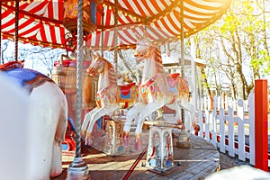 Vintage Merry-Go-Round flying horse carousel in amusement holliday park