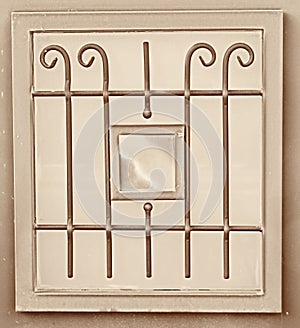 Vintage metal art ornamentation window. sepia filtered image