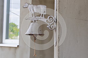 Vintage Metal Cow Bell Hanging on a Wall with Rustic Charm