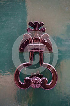 Vintage metal knocker on a wooden door