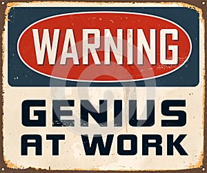 Vintage Rusty Warning Genius At Work Metal Sign. photo
