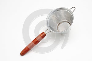 Vintage metal strainer for kitchen on white background