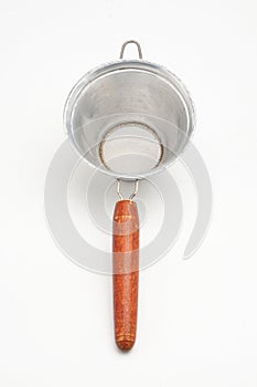 Vintage metal strainer for kitchen on white background