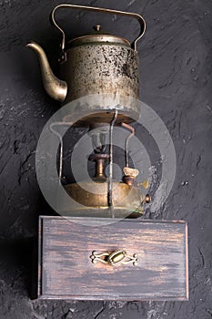 Vintage metallic kettle on a shelf.