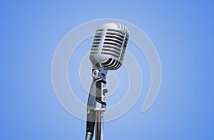 Vintage Microphone over blue background