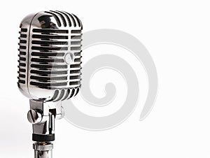 A vintage microphone is shown against a white background