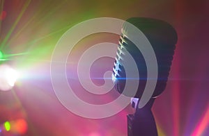 Vintage microphone with stage disco lights.
