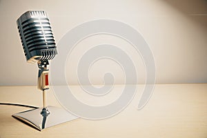 Vintage microphone on white wooden table