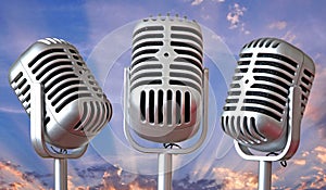 Vintage microphones trio with sun rays sky