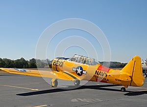 Vintage military war plane on runway at airshow.