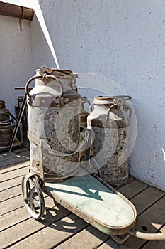 Vintage milk churns with cart photo