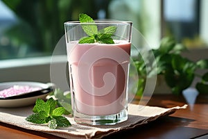 Vintage milk glass with strawberry milkshake on wooden background with fresh strawberries