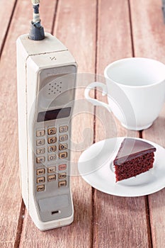 Vintage mobile phone with cup
