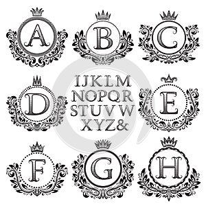 Vintage monogram kit. Black patterned letters and floral coat of arms frames for creating initial logo in antique style