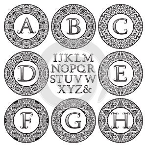 Vintage monogram kit. Black patterned letters and floral round frames for creating initial logo in victorian style