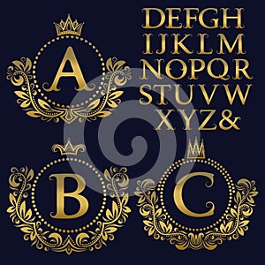 Vintage monogram kit. Golden letters and floral coat of arms frames for creating initial logo in antique style