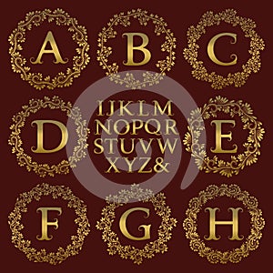 Vintage monogram kit. Golden letters and floral round frames for creating initial logo in antique style