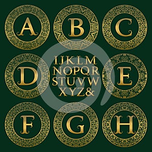 Vintage monogram kit. Golden letters and floral round frames for creating initial logo in antique style