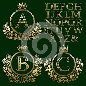 Vintage monogram kit. Golden patterned letters and floral coat of arms frames for creating initial logo in antique style