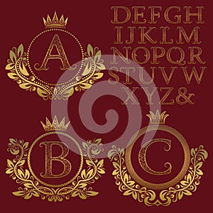 Vintage monogram kit. Golden patterned letters and floral coat of arms frames for creating initial logo in antique style