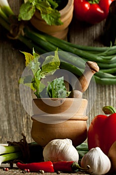 Vintage mortar and mix of vegetables with reflex