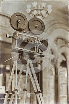 Vintage movie camera on a tripod, model. Processed with retro style. Cinema concept and other antiquities. For