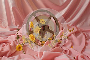 A vintage movie projector reel. draped across a pastel pink velvet cushion. By generative ai