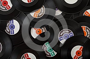 Vintage music, recording studio and audio disc concept with close up on a pile of many classic vinyls with each vinyl record a