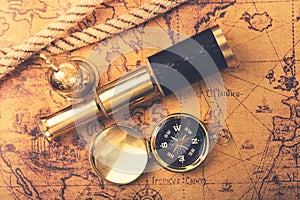 Vintage navigation equipment on old world map. top view