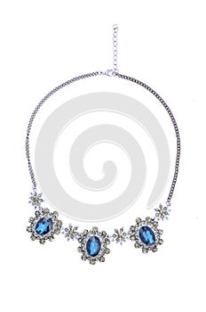 Vintage necklace with blue gems on a white background