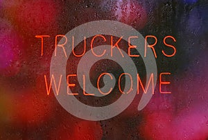 Vintage Neon Sign in Rainy Window Truckers Welcome