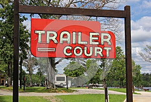 Vintage Neon Trailer Court Sign at RV Park Near Lake