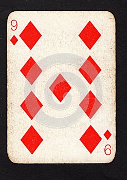 A vintage nine of diamonds playing card on a black background.