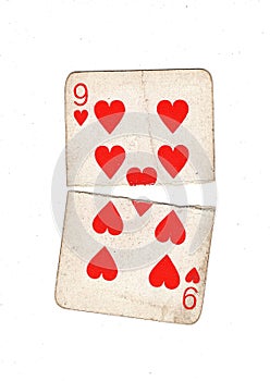 A vintage nine of hearts playing card torn in half.