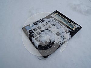 Vintage not working photocell calculator with snow-covered buttons stock image