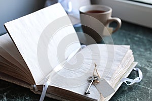 Vintage notebook on green marble windowsill opened with blank pa