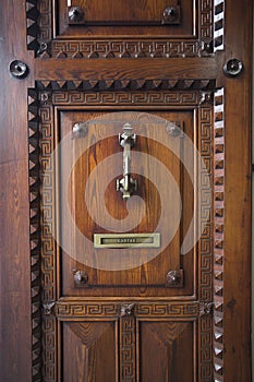 Vintage oak door in Spain with knock knob and mailbox labeled cartas photo