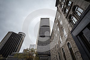 Vintage office skyscraper taken from a nearby street in the district of the Old Montreal, or Vieux Montreal, in the city of Montre