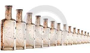 Vintage oil and tincture glass bottles weathered on white background. Duplicated Old bottles with calcium deposits