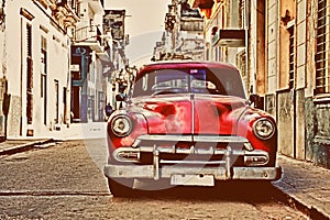 Vintage old american red car parked in a street of havana photo