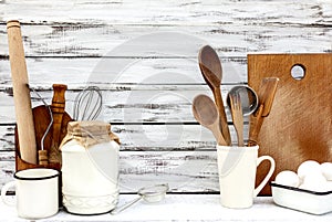 Vintage old baking utensils on a white wooden background