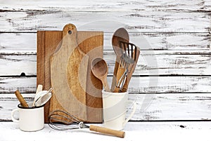 Vintage old baking utensils on a white wooden background