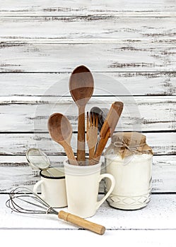 Vintage old baking utensils on a white wooden background