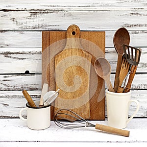 Vintage old baking utensils on a white wooden background