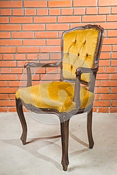 Vintage old black wooden chair in grungy interior. Loneliness, estrangement, alienation concept