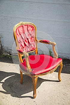 Vintage old black wooden chair in grungy interior. Loneliness, estrangement, alienation concept