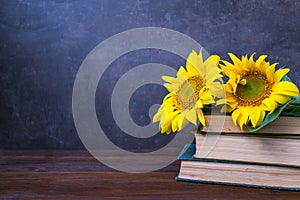 Vintage Old books and bouquet of sunflowers. Two books with bright yellow flowers. Retro nostalgic vintage background. Reading,