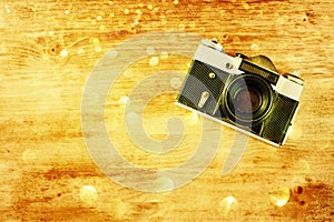 Vintage old camera on brown wooden background